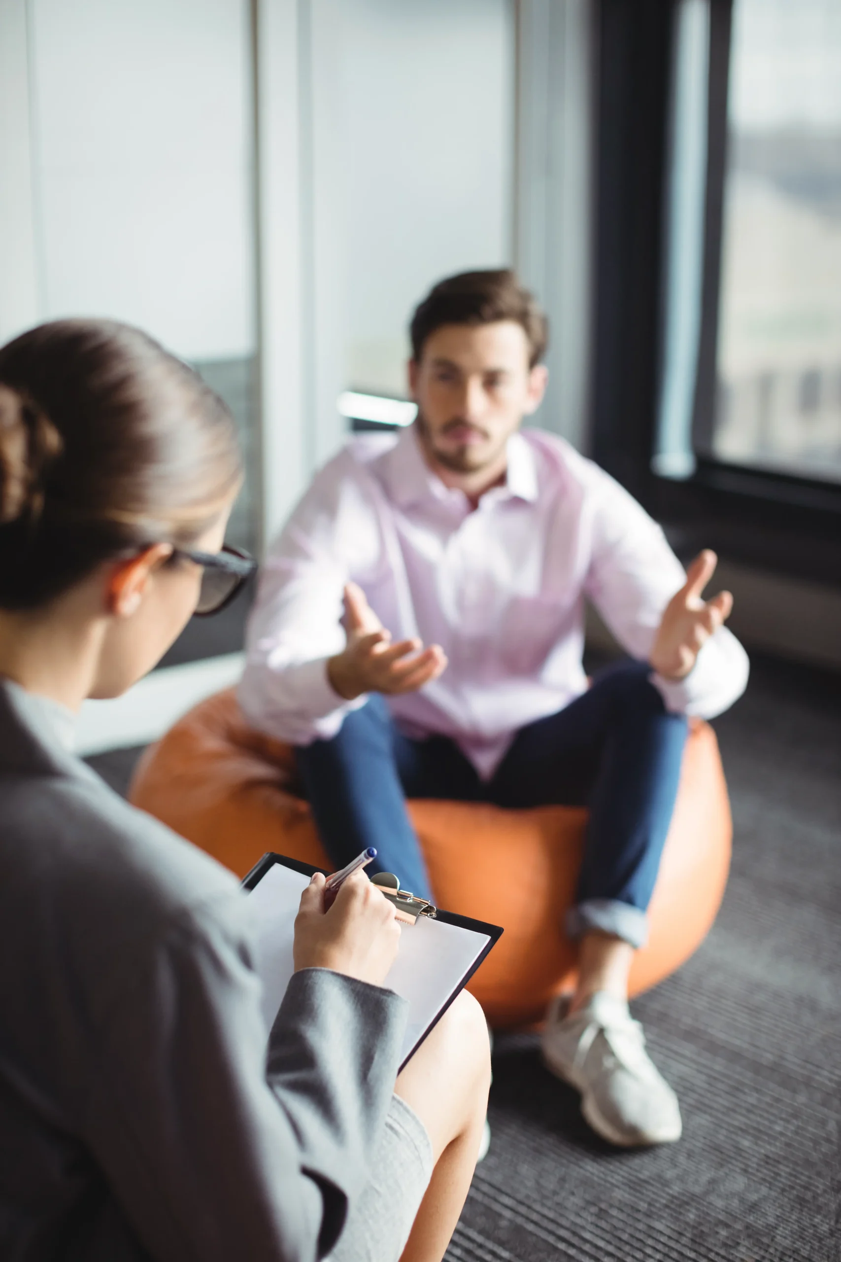 woman therapist talking to man